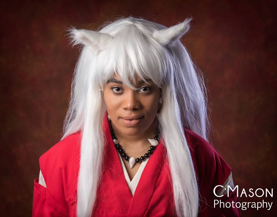 Inuyasha wears white dog ears and long white hair, a red kimono top and a black and white necklace.